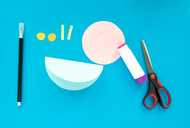 istock Step by step children's cardboard crafts - colored swinging snail. Scissors, glue, paper sheets. Set for kids art. Children activity in kindergarten, school, at home. Step 4 1251528063