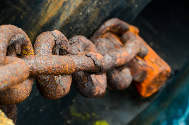 Rusty Ship Anchor Chain On Dry Coast In The Port