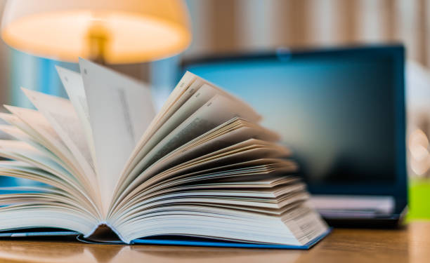 istock Open book lying on the table in the library 1251529554