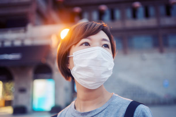 istock Woman with face protective mask 1251530385