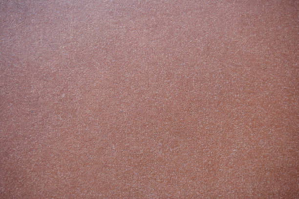 Empty abstract background for design. Matte monochrome burgundy surface with a fine texture