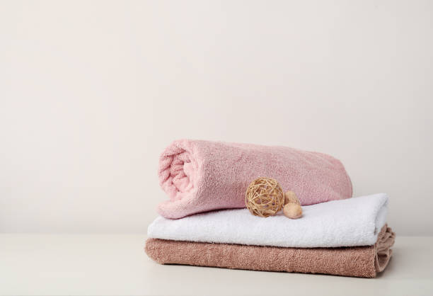 istock Stack of bath towels with bamboo balls on white background 1251531412