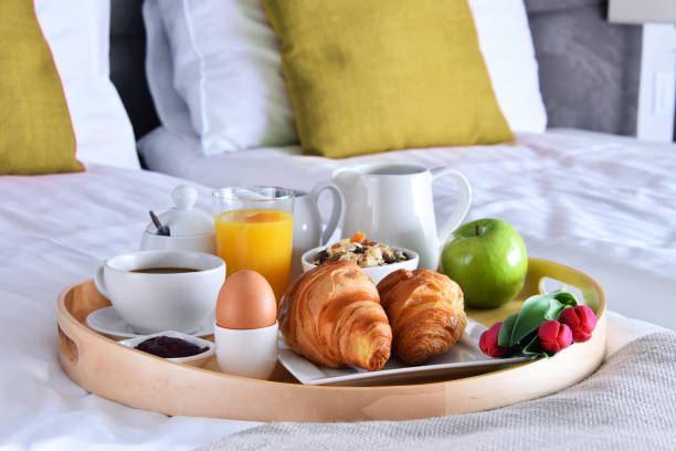 istock Breakfast on tray in bed in hotel room 1251531488