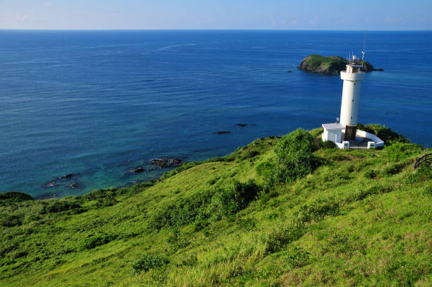 istock Lighthouse on a cape in Okinawa, Japan 1251531617