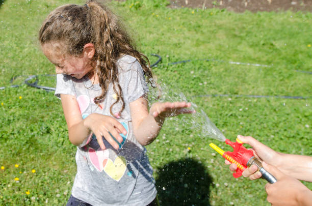 istock Boy and girl splashing each other 1251534828