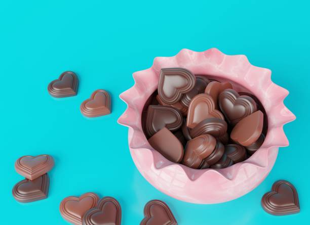 chocolate hearts in pink candy dish - valentines day candy chocolate candy heart shape imagens e fotografias de stock