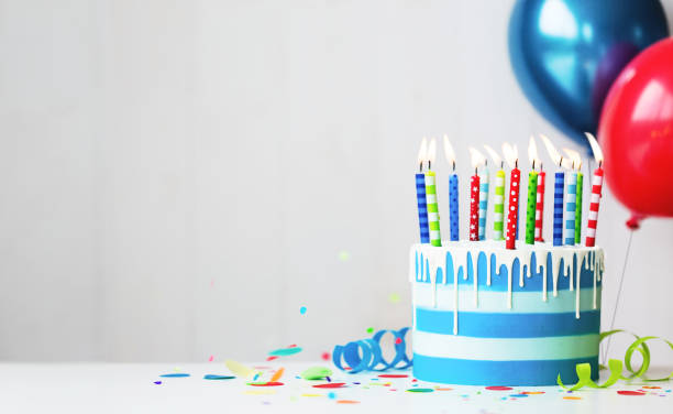 Colorful birthday cake with candles and balloons Colorful striped buttercream birthday cake with birthday candles and balloons birthday cake photos stock pictures, royalty-free photos & images