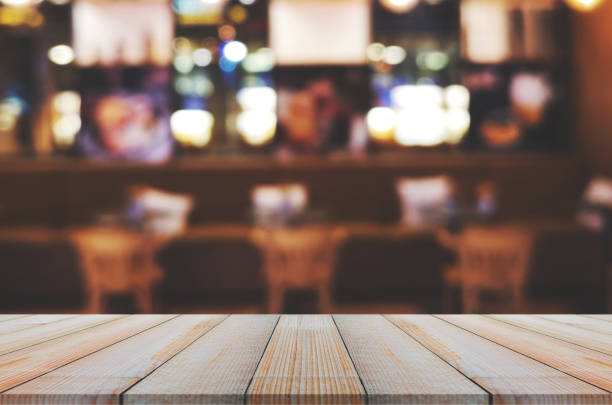 istock wooden table with abstract blurred background resturant lights used for display montage products mock up design. 1251538257