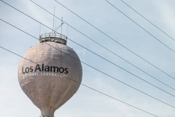 City in New Mexico with view of water tower tank on road with sign for National Laboratory Los Alamos, USA - June 17, 2019: City in New Mexico with view of water tower tank on road with sign for National Laboratory los alamos new mexico stock pictures, royalty-free photos & images