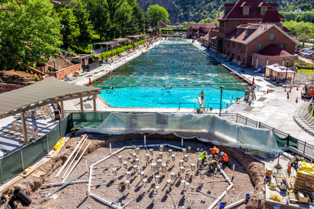 Aerial view of famous Colorado hot springs pool in downtown with water Glenwood Springs, USA - July 10, 2019: Aerial view of famous Colorado hot springs pool in downtown with water and people swimming garfield county montana stock pictures, royalty-free photos & images