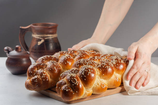 Woman holding just made Challah bread