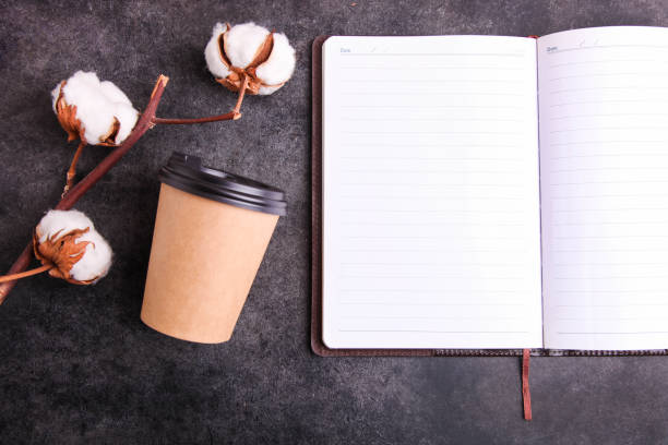 istock Men's notebook and disposable cup with coffee 1251538792