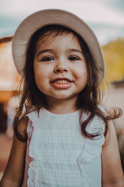istock Cute little girl with her summer hat 1251540231