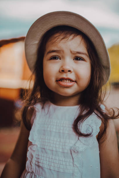 istock Cute little girl with her summer hat 1251542252