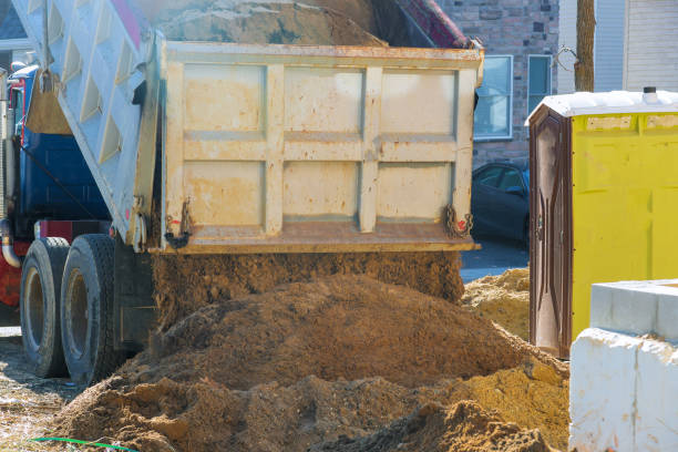istock Truck pour soil on the ground in construction area. 1251542918