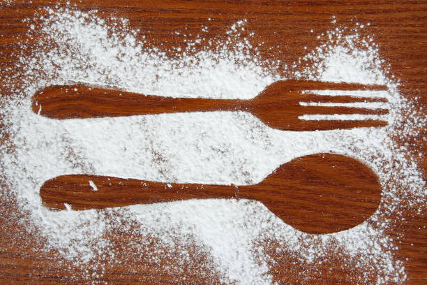 istock Fork and a Spoon shadow. Fork and a Spoon made of sugar powder. 1251544007