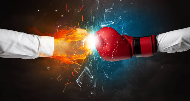 istock Fighting hands breaking glass with fire and water 1251544835