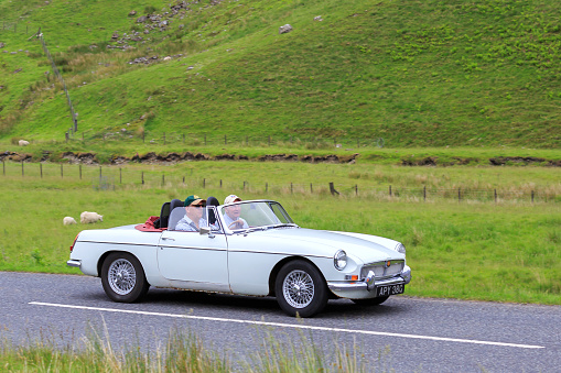 Moffat, Scotland - June 29, 2019: 1968  MG MGB Roadster Sports car in a classic car rally en route towards the town of Moffat, Dumfries and Galloway