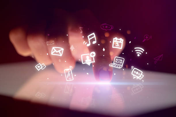 istock Finger touching tablet with hologram app icons above 1251546375