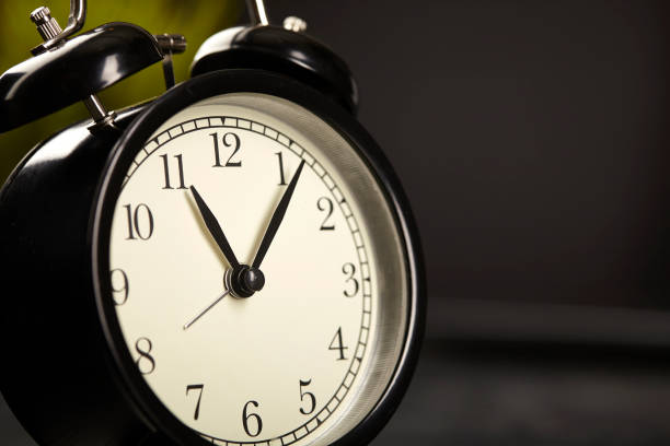 istock Alarm clock on a black background with copy space. Close up. 1251549002