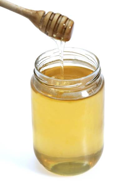 istock Pot of Honey with Honey Spoon 1251549268