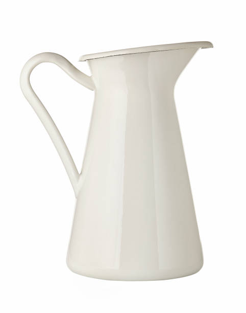 istock White metal pitcher. Isolated on white background. Close up. 1251549298