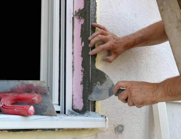 istock The worker's hand puts glue on the styrofoam with a spatula 1251550006