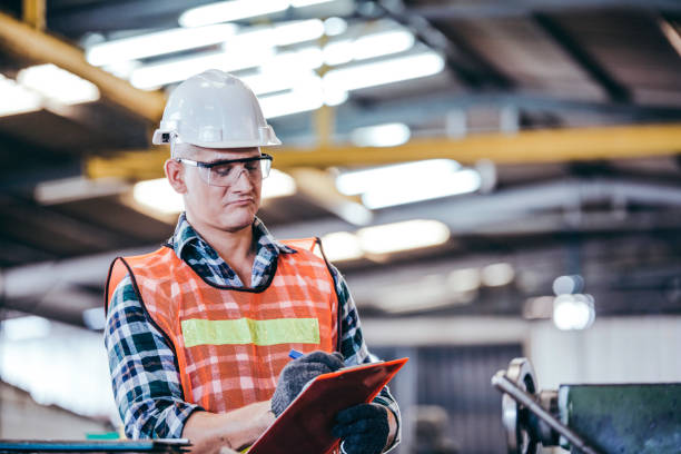 istock Portrait handsome smart engineer male manager working on construction repair checklist document in modern industrial manufacturing factory. worker man in protective uniform work hard. copy space 1251551396