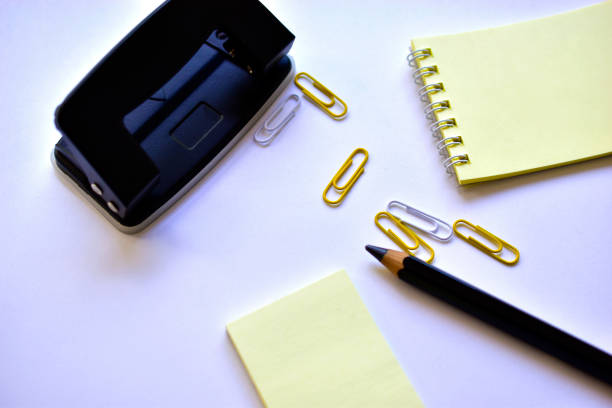 istock Black large pencil Notepad paper clips and black office hole punch 1251551702