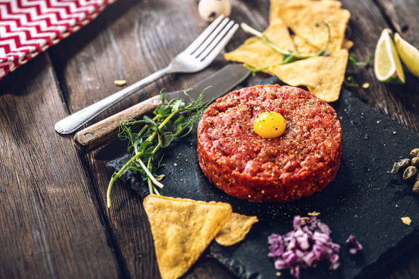 beef tartare with quail egg and spices - tartar sauce imagens e fotografias de stock