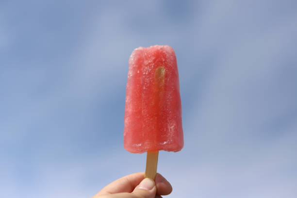 istock A pink popsicle held up to a blue sky 1251553876