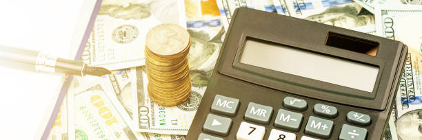 istock calculator with grey and white buttons lies on banknotes 1251557332