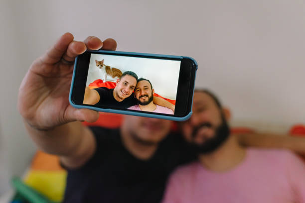 istock Two men taking a selfie with LGBT flag. 1251557917
