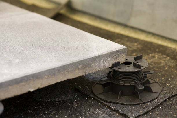 istock Laying concrete slabs on an adjustable bracket with smooth height adjustment 1251558064