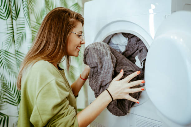 istock Young woman doing her laundry at home 1251558544