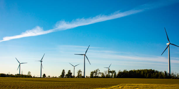 istock Group of giant wind generators at sunset 1251560278