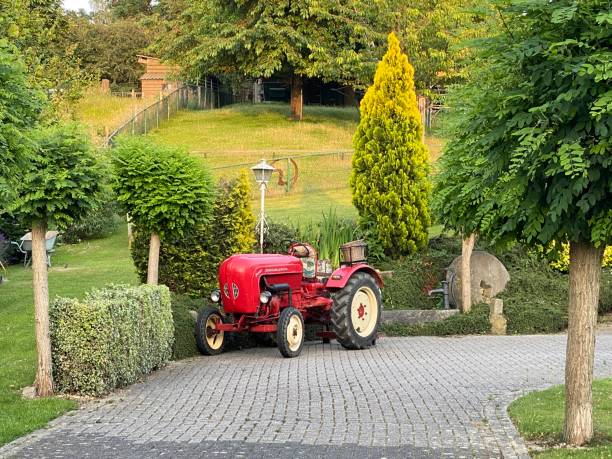 Vintage tractor Brunssum, the Netherlands, - June 22, 2020. Vintage tractor parked in a Summer garden. garden tractor stock pictures, royalty-free photos & images