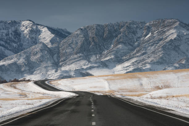 istock Road in winter mountains. Sunny weather. 1251565497