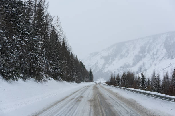 istock Road in winter mountains. Cloudy weather. 1251565506