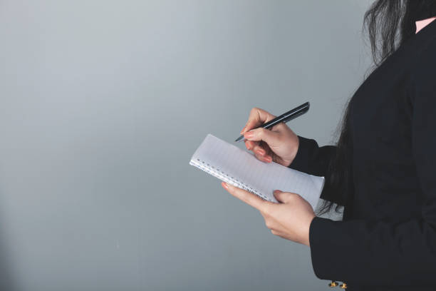 istock woman hand pen and notepad 1251567122