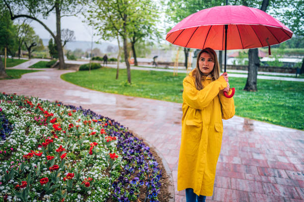 istock Woman with red umbrella 1251567816