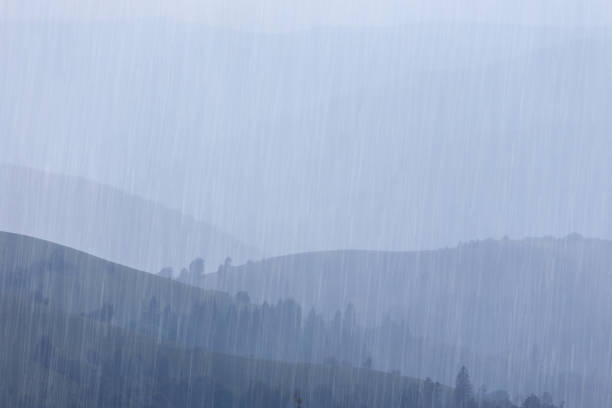 Rain over forest mountains. Misty mountain landscape hills at rainy day.