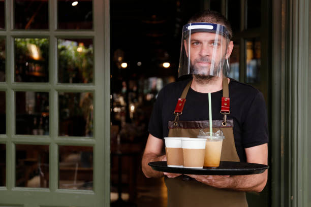 istock Man working in cafe, with face mask 1251573734
