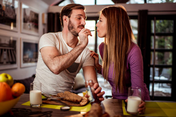 istock Young romantic couple sharing breakfast at home 1251575080