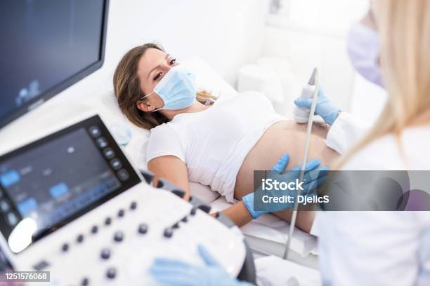 Pregnant Woman On Ultrasound Stock Photo - Download Image Now - Pregnant, Ultrasound, Women