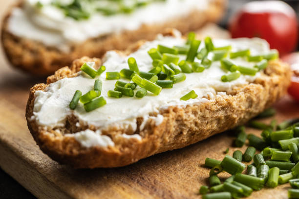 Crispbread with creamy cheese., green chive and tomatoes