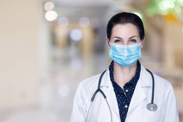 istock A female doctor in a mask stands . 1251576605
