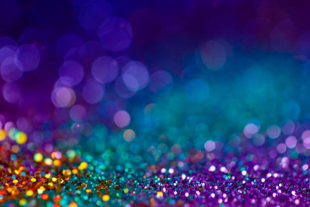 istock Decoration twinkle lights background, abstract blurred backdrop with circles,modern design overlay with sparkling glimmers. Blue, purple, golden and green backdrop glittering sparks with glow effect. 1251584859