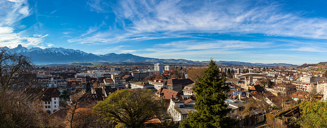 Stunning aerial panorama view of Thun cityscape from Thun Castle with snow covered mountain peaks of Swiss Alps on Bernese Oberland in background, a sunny autumn day, Thun, Canton of Bern, Switzerland