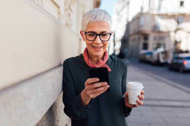 istock Happy senior woman using her smart phone 1251586009